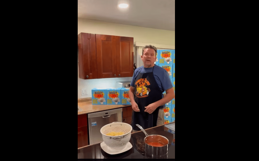 A man standing in front of a kitchen counter.